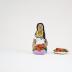 Kneeling Muñeca in White and Purple Dress with Carrots and Plate of Carrots