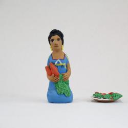 Kneeling Muñeca in Blue Dress with Carrots and Plate of Carrots